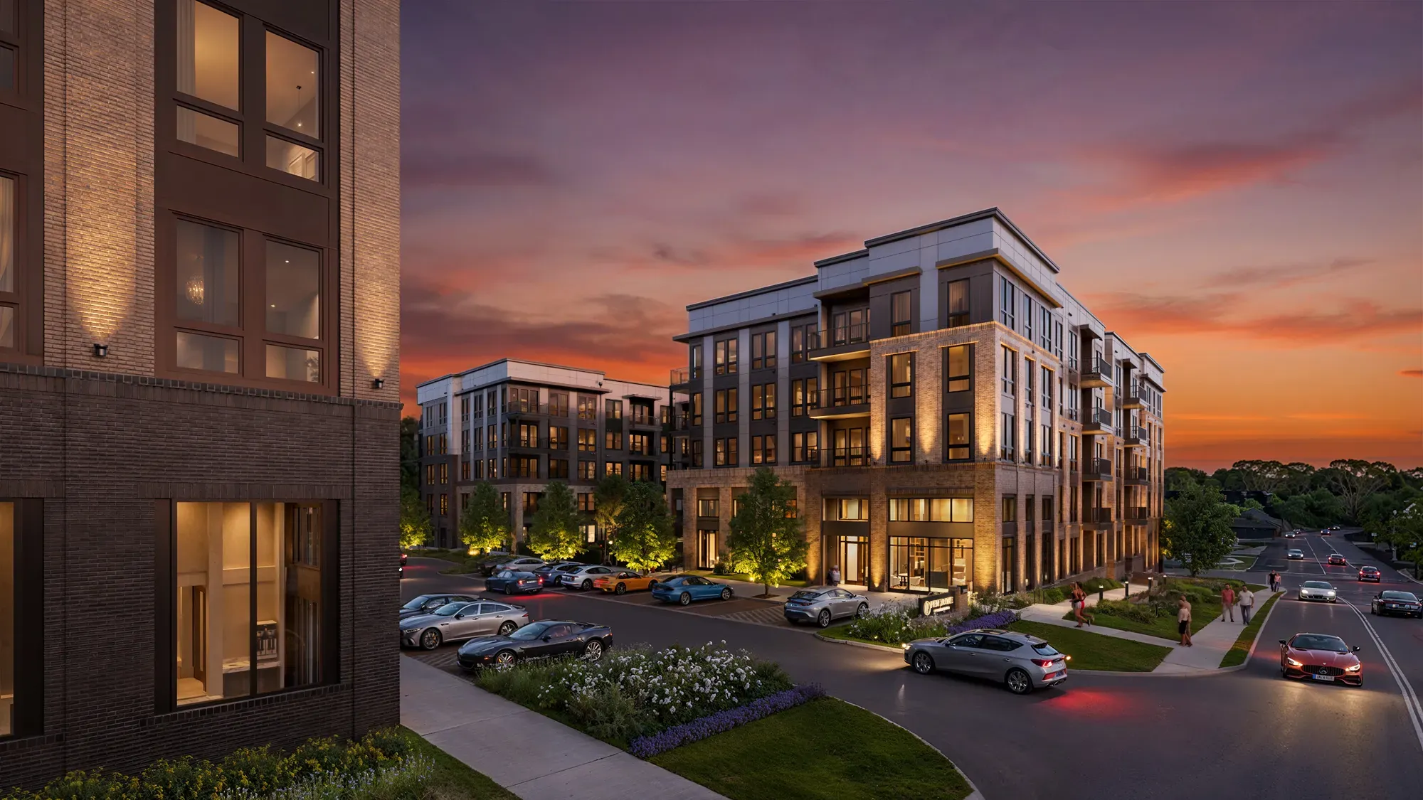 Pembroke at Friendly Center apartment building glowing at sunset with a lit entrance in Greensboro, NC