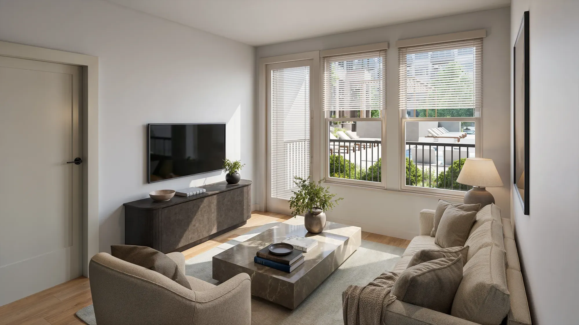 Bright apartment living room with sofa, marble coffee table and pool-view windows at Pembroke, Greensboro, NC