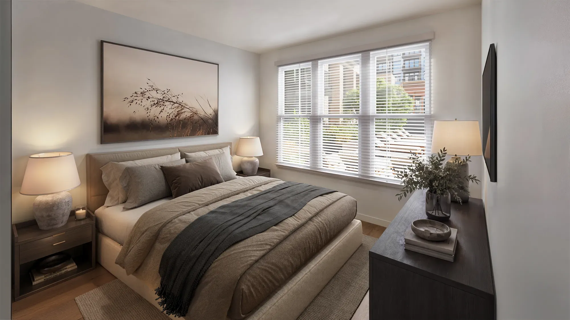 Cozy apartment bedroom with upholstered bed, bedside lamps and large window at Pembroke, Greensboro, NC